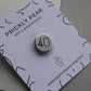 A silver sleep 40th birthday badge on a white card.