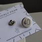 A sleek silver number 40 birthday badge. Badge uses a butterfly back which is shown behind the pin.