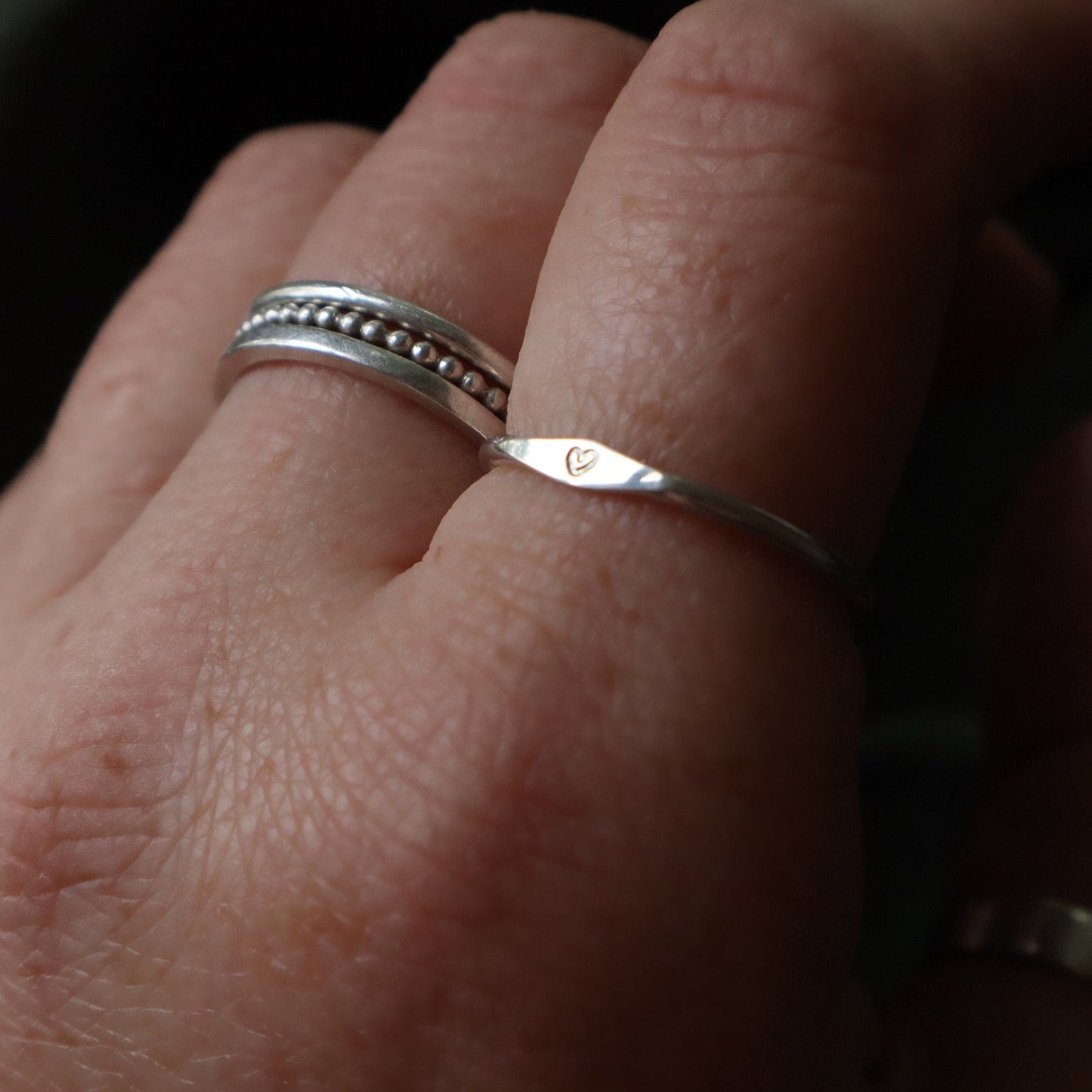 Signet ring with a heart stamped onto it.