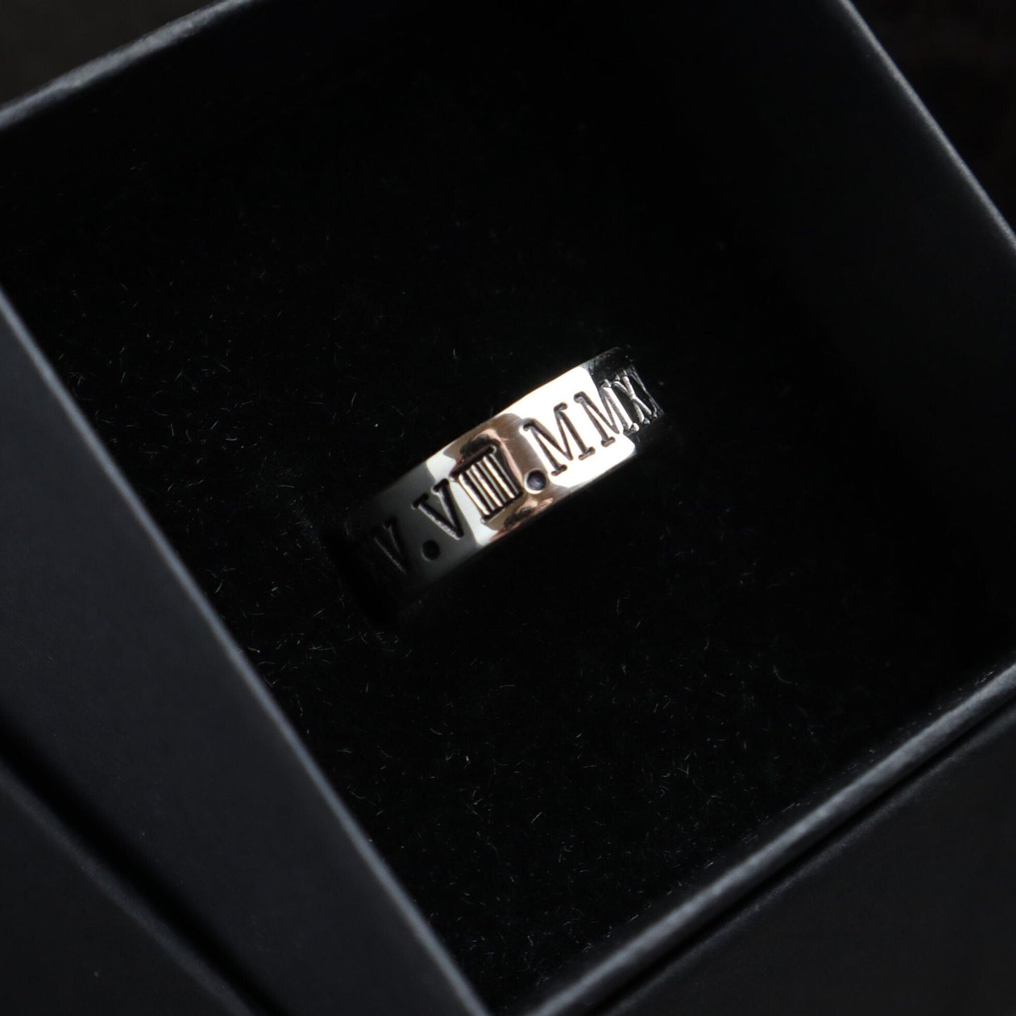 Chunky Sterling Silver band with roman numerals stamped into the face of the band, the ring is in a luxury black ring box.