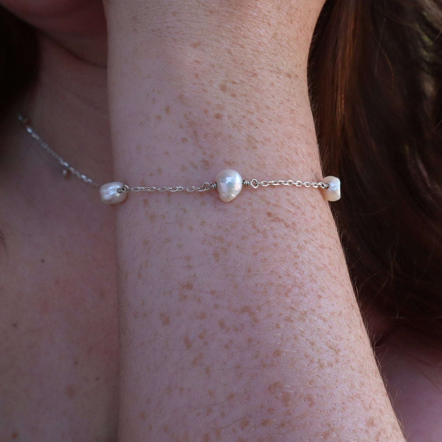 Pearl Satellite Bracelet displayed on a a ladies wrist.