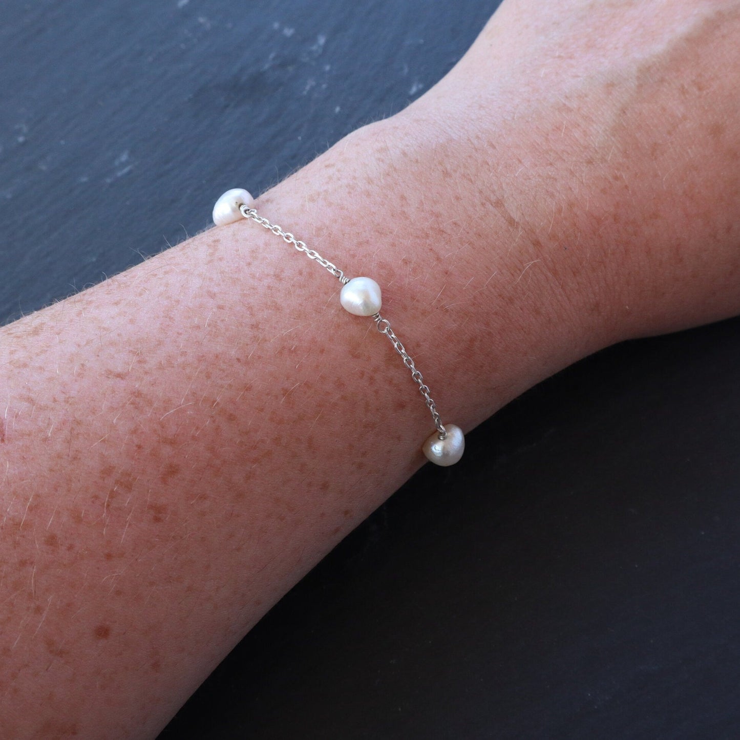 Pearl Satellite Bracelet displayed on a ladies wrist.
