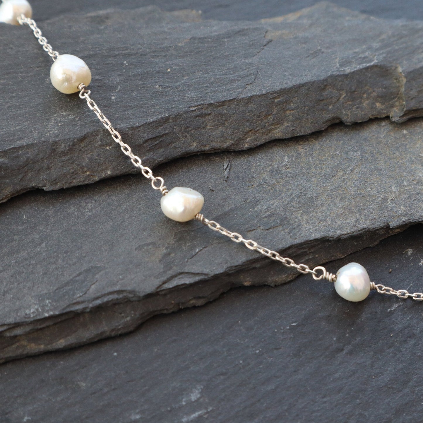 Satellite Pearl Bracelet displayed on a slate background.